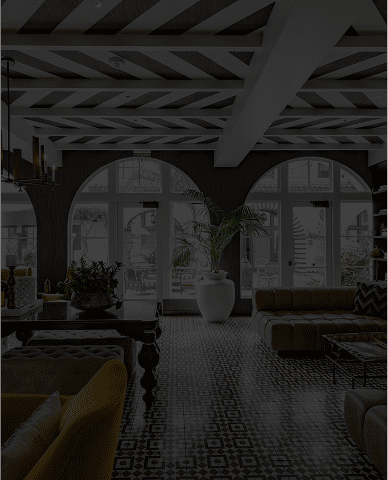 Elegant room with vintage furniture and large windows.